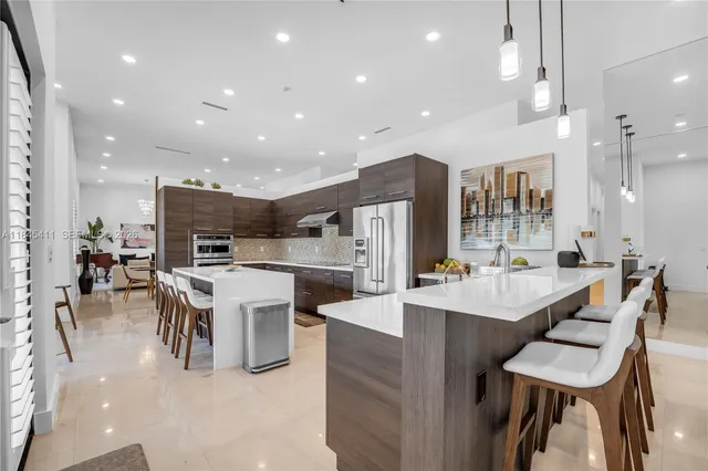 a kitchen with kitchen island a large window in it