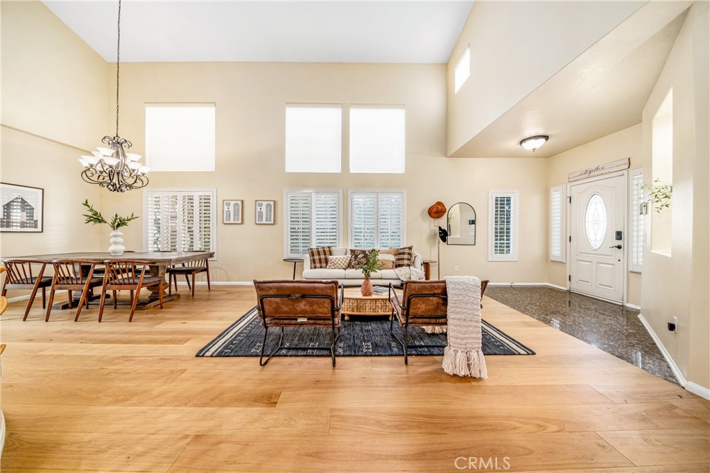 11358 Ferrara Lane Porter Ranch, CA 91326 - Photo 1 of 1 a living room with furniture and a chandelier