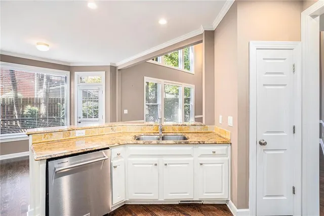 a view of a kitchen with granite countertop cabinets and a large window