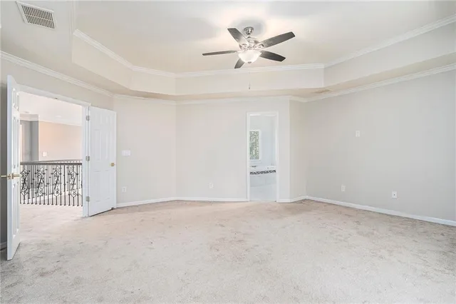 an empty room with windows and ceiling fan