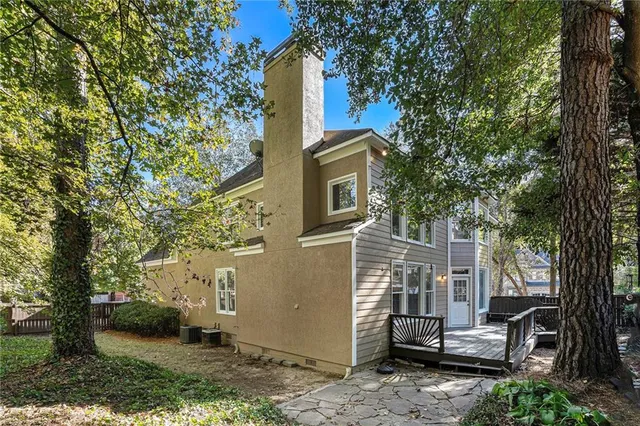 a view of a patio with furniture and a tree