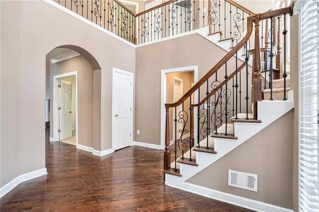 a view of an entryway with wooden floor and stairs