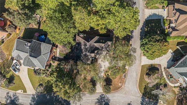an aerial view of a house with a yard and swimming pool