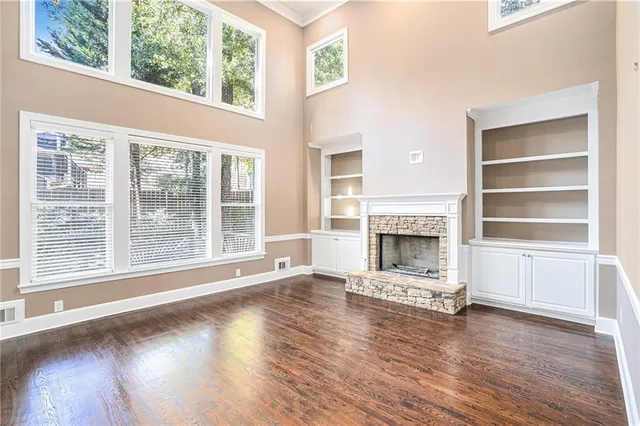 a living room with a fireplace and wooden floor