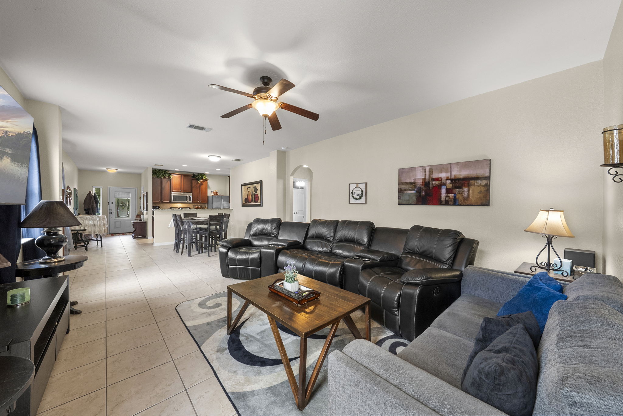1617 Treeta Trail Kyle, TX 78640 - Photo 4 of 39 Living room featuring light tile patterned floors, arched walkways, and ceiling fan