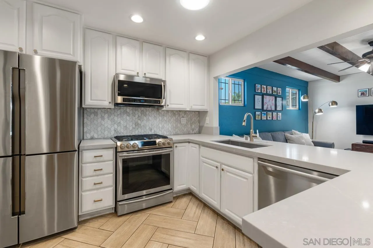 10113 Gem Tree Way Santee, CA 92071 - Photo 18 of 49 a kitchen with stainless steel appliances a stove a sink and a refrigerator
