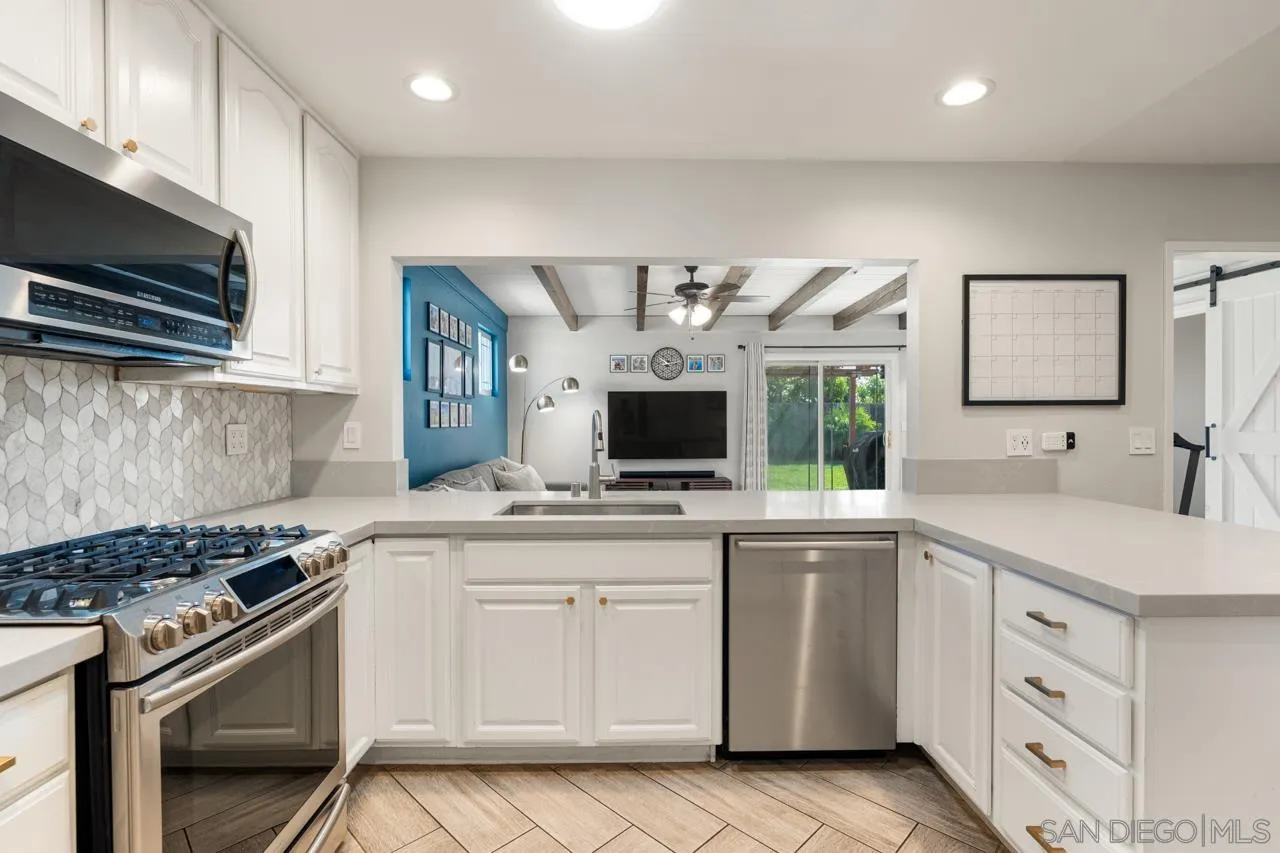 10113 Gem Tree Way Santee, CA 92071 - Photo 19 of 49 a kitchen with a sink stove and microwave