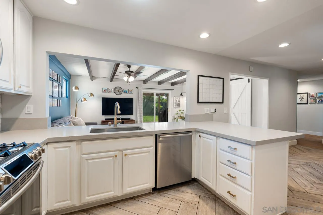 10113 Gem Tree Way Santee, CA 92071 - Photo 20 of 49 a kitchen with white cabinets and a sink