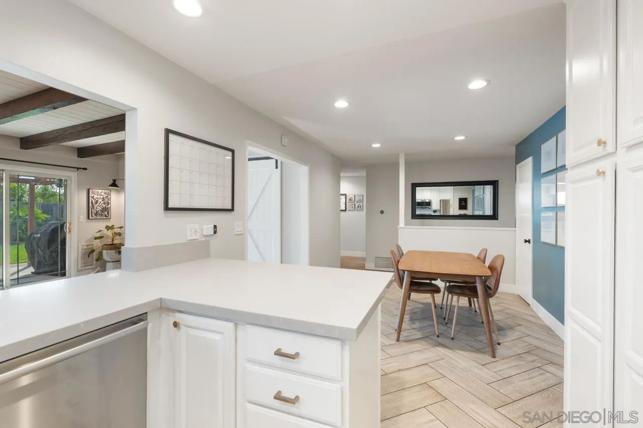 10113 Gem Tree Way Santee, CA 92071 - Photo 21 of 49 a kitchen with a dining table chairs and large window