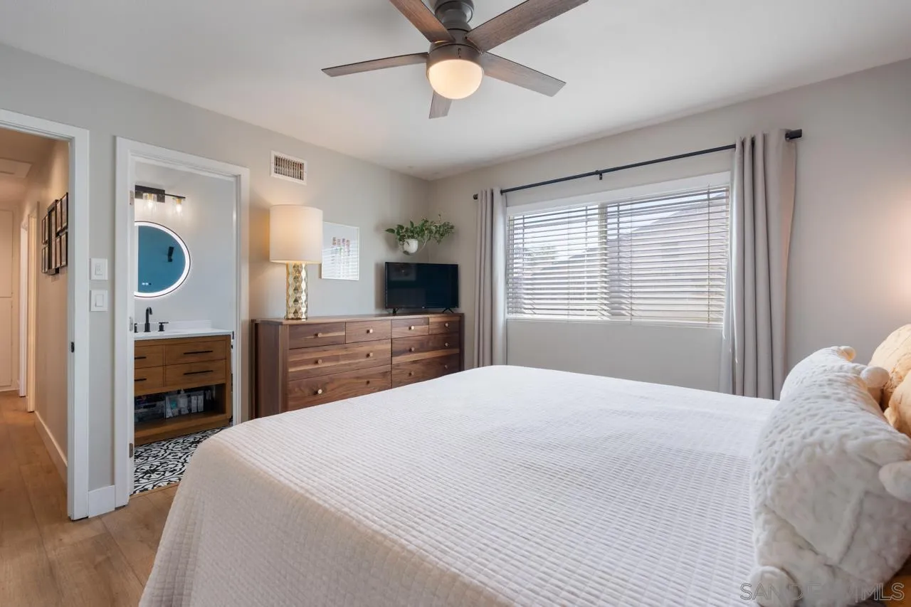 10113 Gem Tree Way Santee, CA 92071 - Photo 25 of 49 a bedroom with a bed and a chandelier