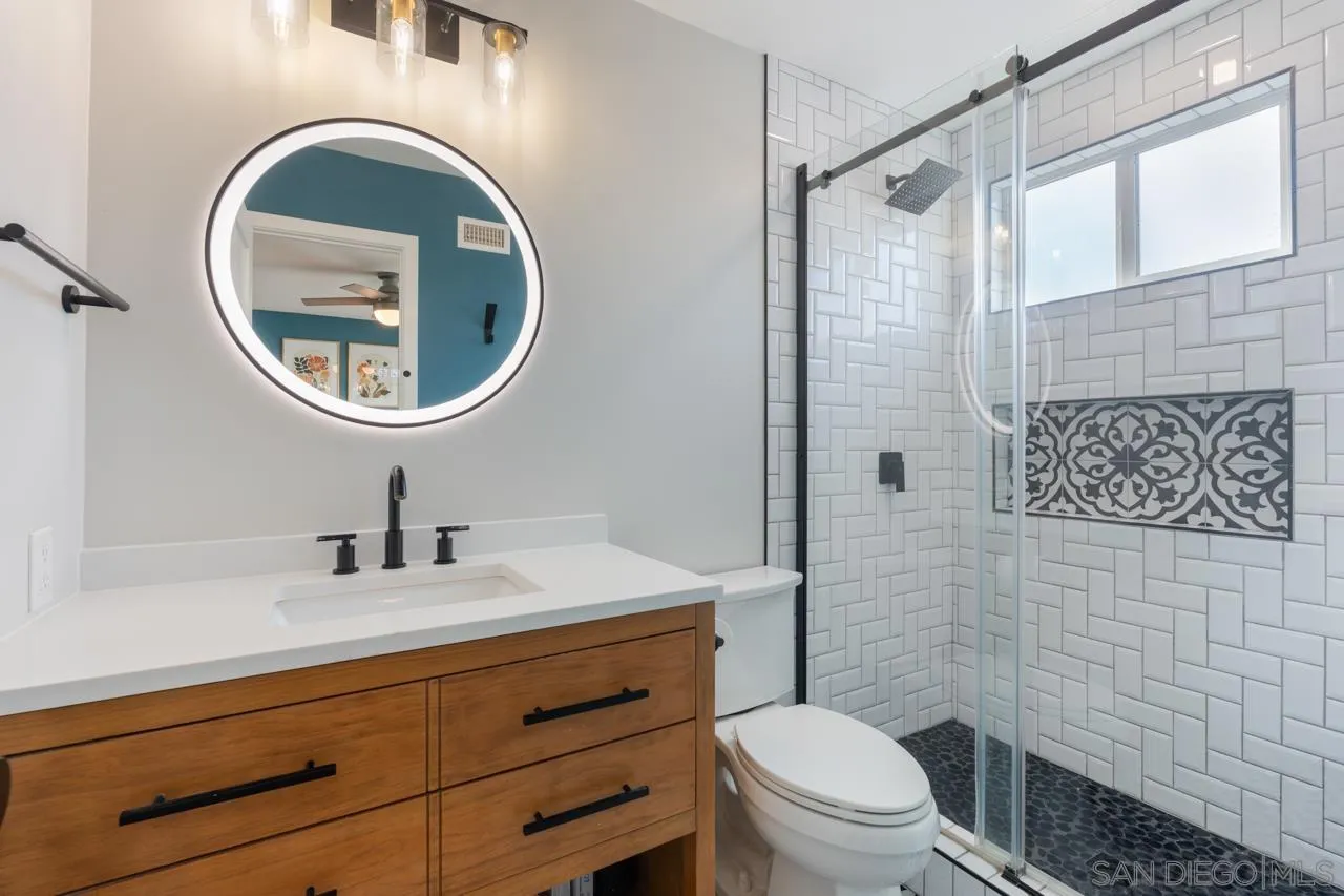 10113 Gem Tree Way Santee, CA 92071 - Photo 26 of 49 a bathroom with a toilet a sink and a mirror