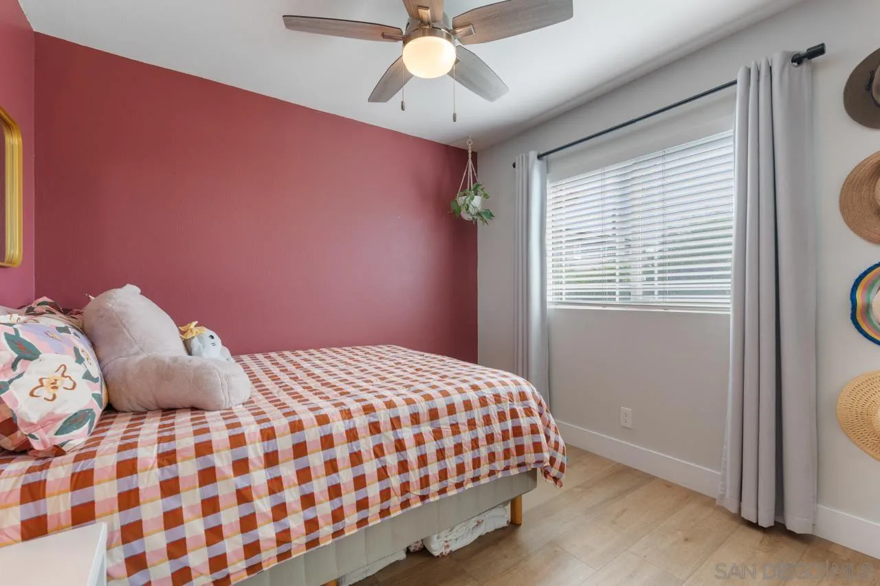 10113 Gem Tree Way Santee, CA 92071 - Photo 28 of 49 a bedroom with a bed and a chandelier