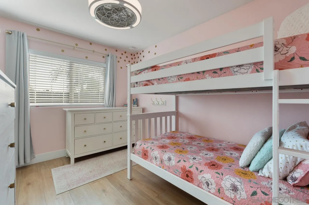 10113 Gem Tree Way Santee, CA 92071 - Photo 30 of 49 a bedroom with a bed a dresser and a window