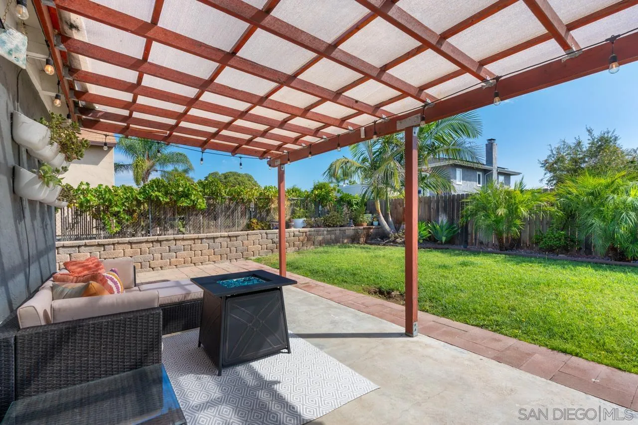 10113 Gem Tree Way Santee, CA 92071 - Photo 34 of 49 a view of a patio with couches and table under an umbrella