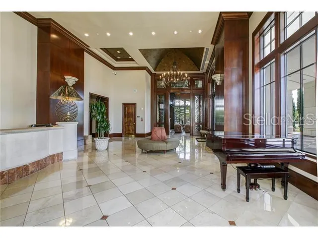 a lobby with furniture and floor to ceiling windows