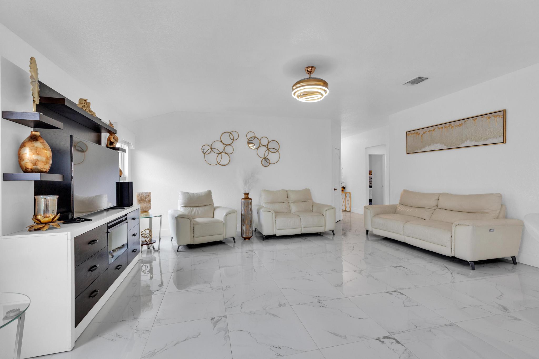 119 Beth Ann Loop Taylor, TX 76574 - Photo 8 of 31 Clean lines and glossy tile flooring define this bright, airy living space.
