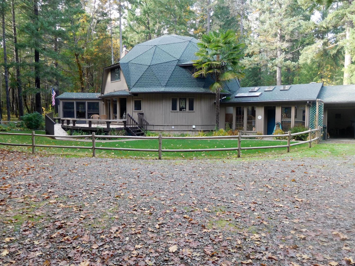 7133 Rockydale Road Cave Junction, OR 97523 - Photo 1 of 23 View of the front of home, from the driv