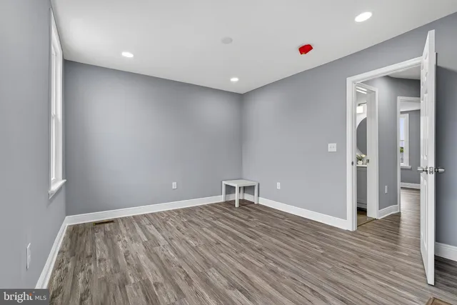 a room with wooden floor and window