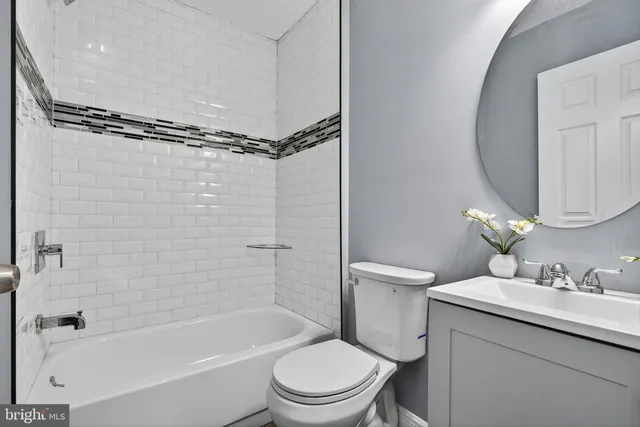 a bathroom with a granite countertop toilet sink and shower