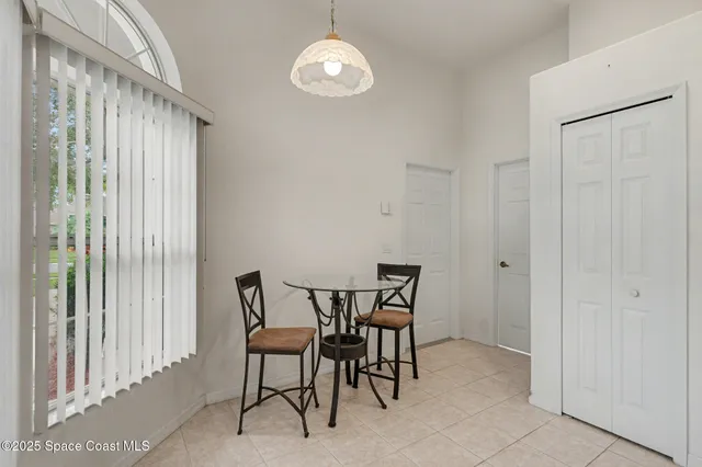 a view of a dining room with furniture and a chandelier