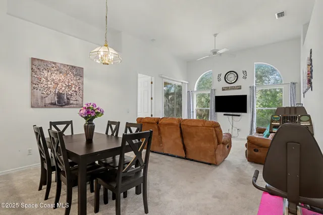 a view of a dining room with furniture and a clock
