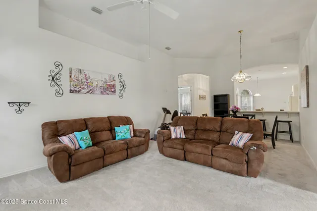 a living room with furniture and kitchen view