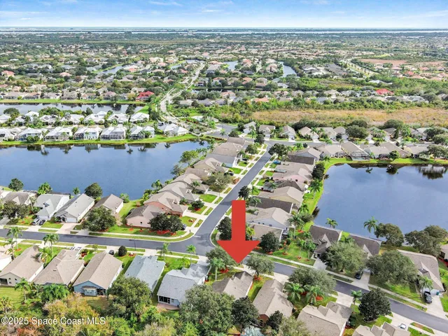 an aerial view of residential houses with outdoor space and swimming pool