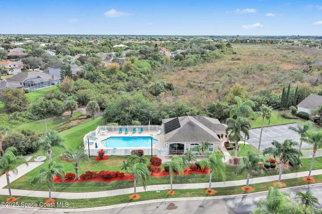 a view of a house with swimming pool and sitting area
