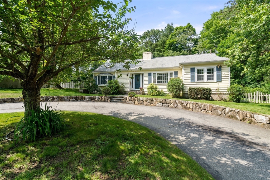 a front view of a house with a garden
