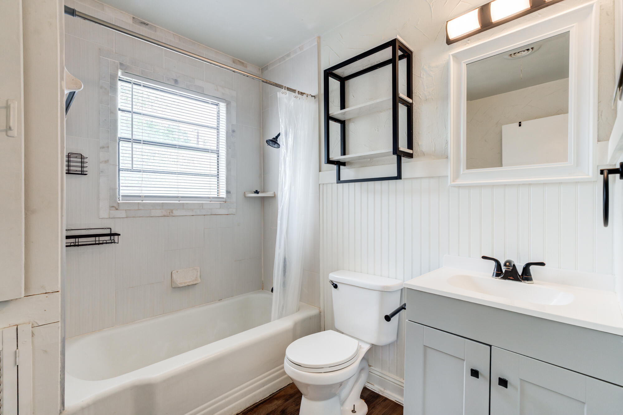 2308 30th Street Lubbock, TX 79411 - Photo 15 of 21 a bathroom with a sink a toilet and a bathtub