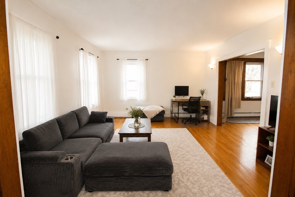 15 Herbert Road, Unit 15 Arlington, MA 02474 - Photo 2 of 9 a living room with furniture and a flat screen tv