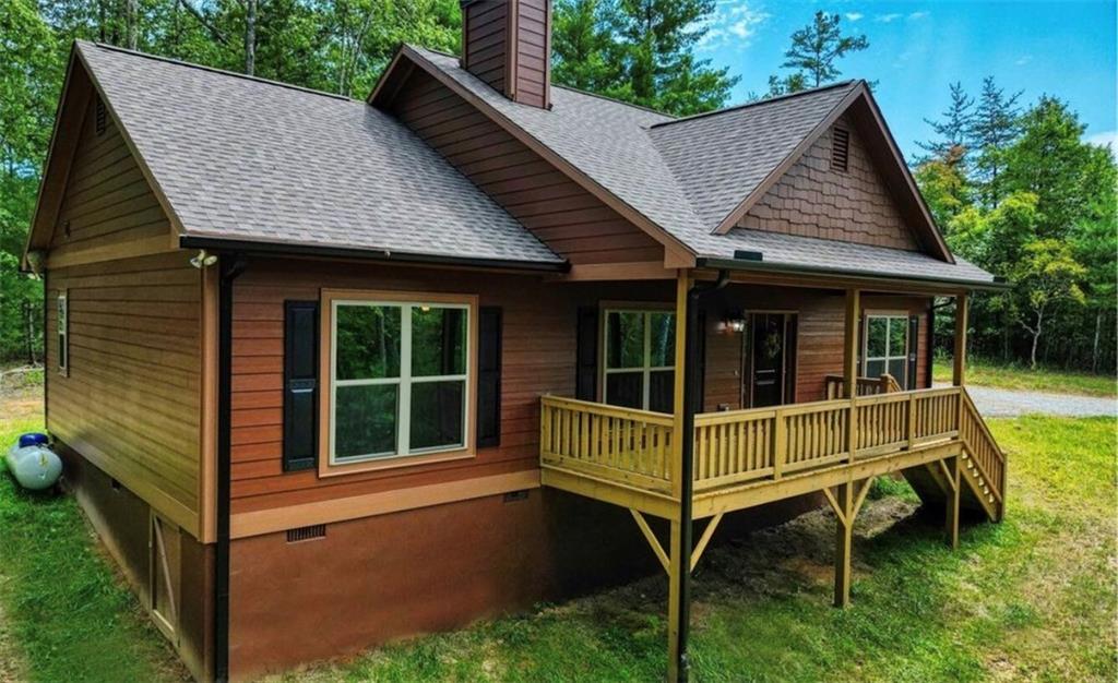 a view of small house with backyard