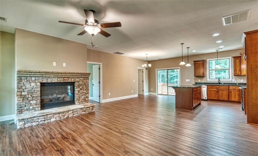 199 Lola Mae Way Morganton, GA 30560 - Photo 12 of 39 a view of an empty room with a kitchen and a fireplace
