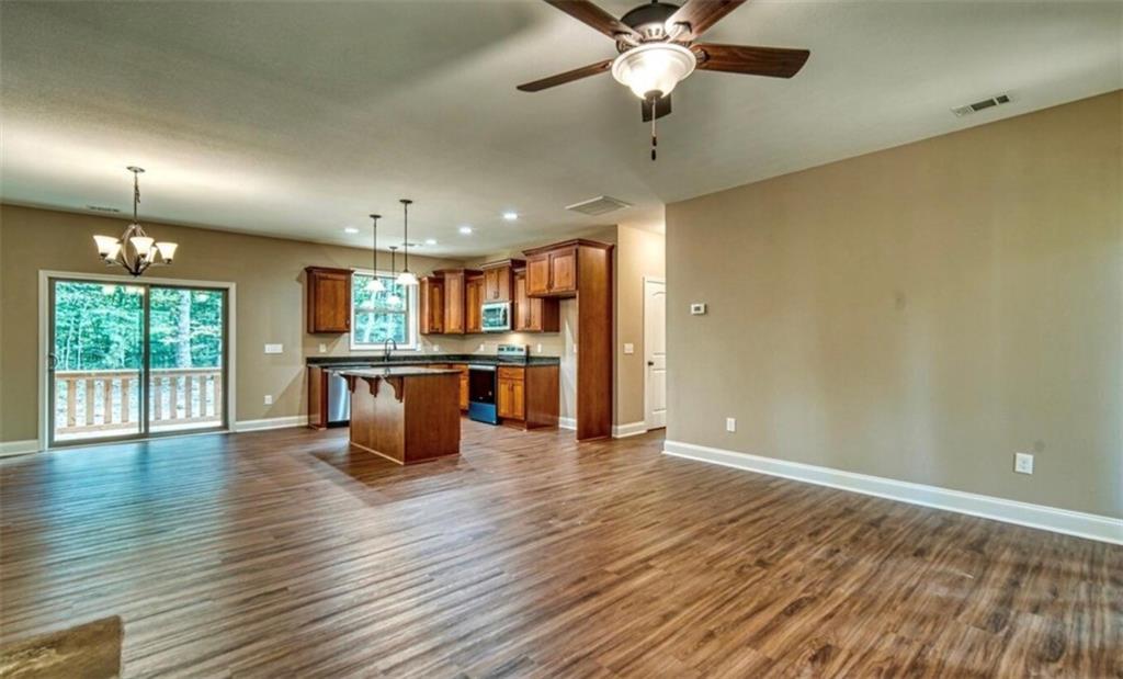 199 Lola Mae Way Morganton, GA 30560 - Photo 13 of 39 an open kitchen with a table and chairs in it