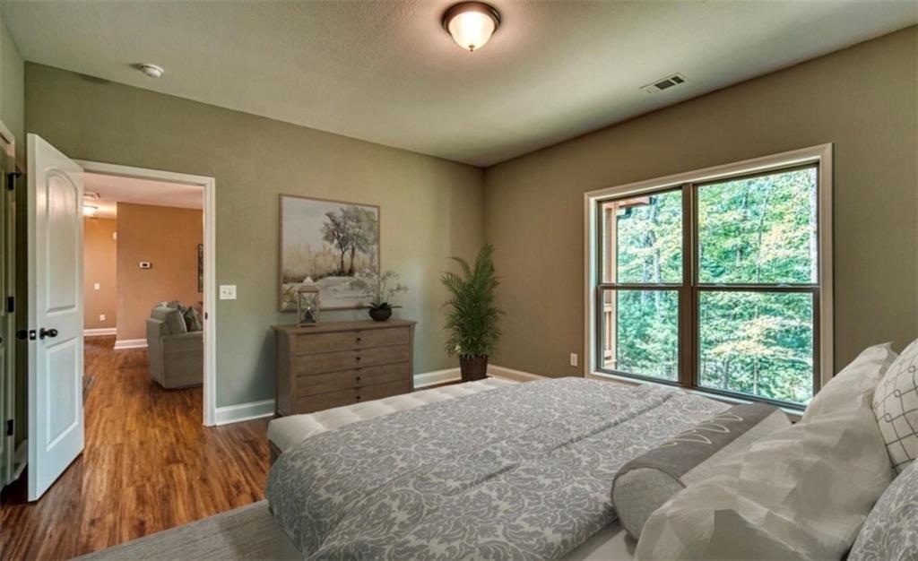199 Lola Mae Way Morganton, GA 30560 - Photo 15 of 39 a bedroom with a bed and a dresser next to a window