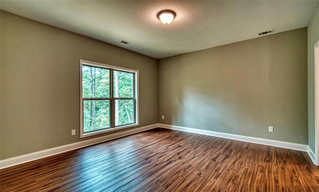 199 Lola Mae Way Morganton, GA 30560 - Photo 18 of 39 wooden floor in an empty room with a window