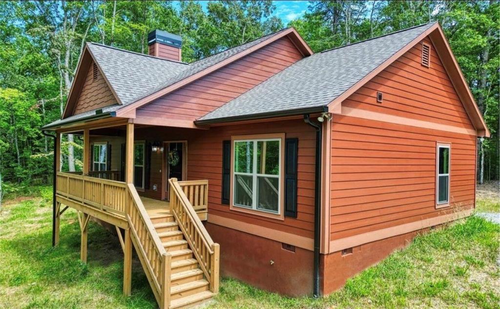 199 Lola Mae Way Morganton, GA 30560 - Photo 2 of 39 a view of house with backyard and sitting area