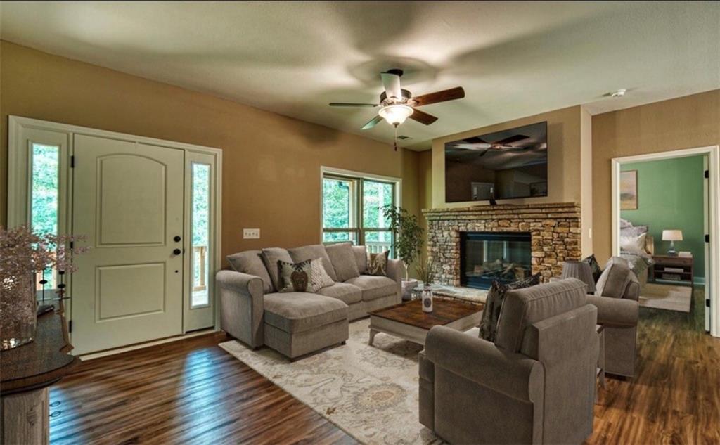 199 Lola Mae Way Morganton, GA 30560 - Photo 26 of 39 a living room with furniture a fireplace and a flat screen tv