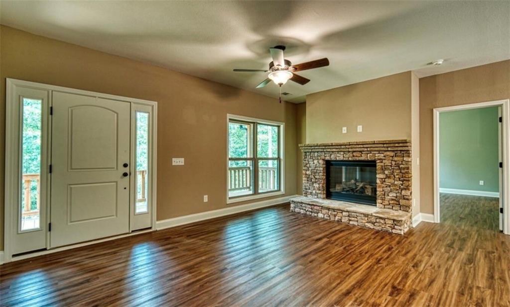 199 Lola Mae Way Morganton, GA 30560 - Photo 27 of 39 a view of an empty room with wooden floor fireplace and a window
