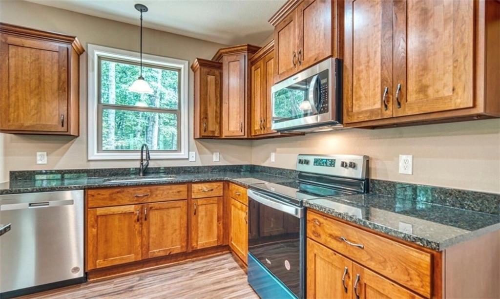 199 Lola Mae Way Morganton, GA 30560 - Photo 8 of 39 a kitchen with stainless steel appliances granite countertop wooden cabinets a sink and a window
