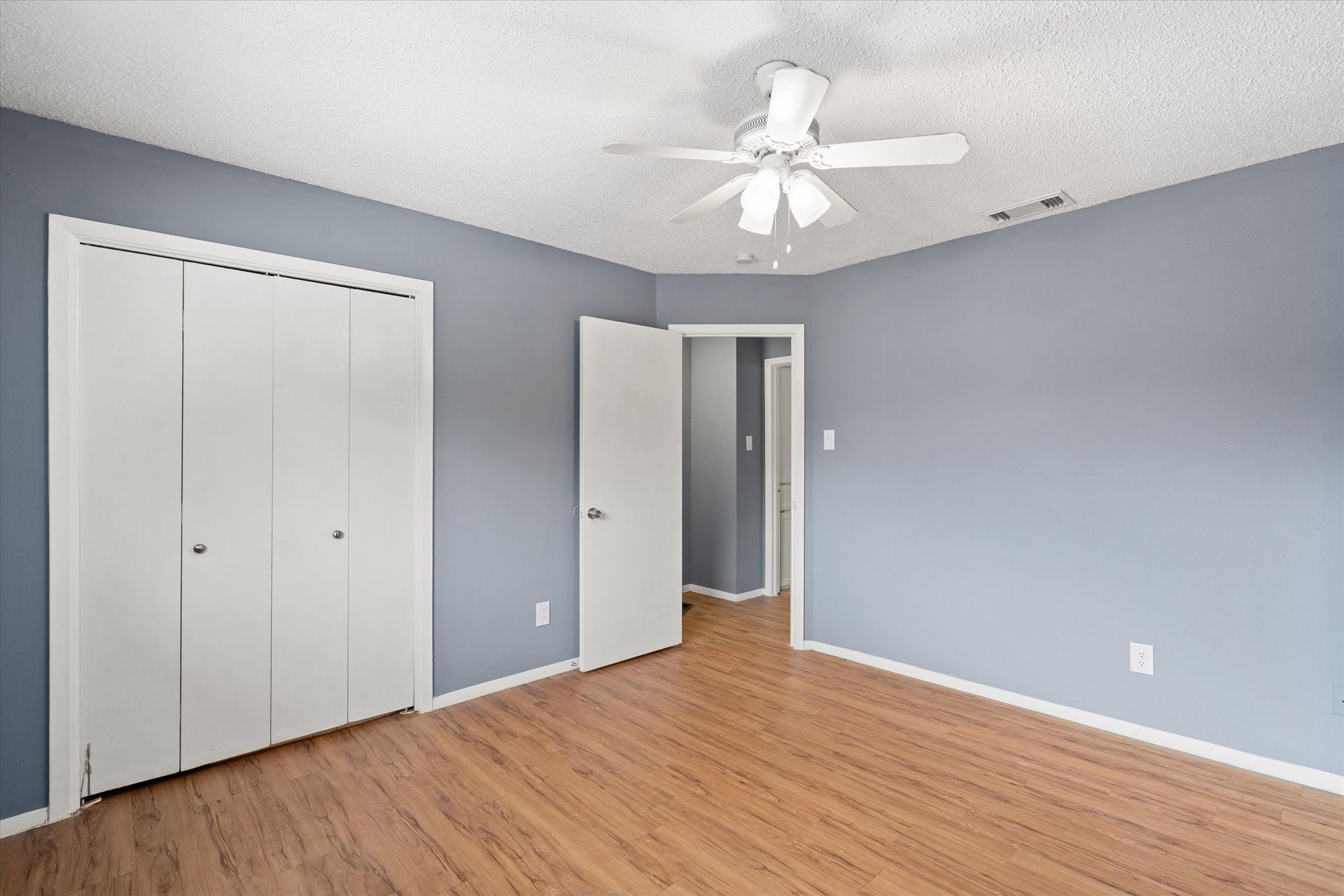 3415 Menchaca Road, Unit 114 Austin, TX 78704 - Photo 9 of 14 Unfurnished bedroom with wood finished floors, visible vents, a closet, and baseboards