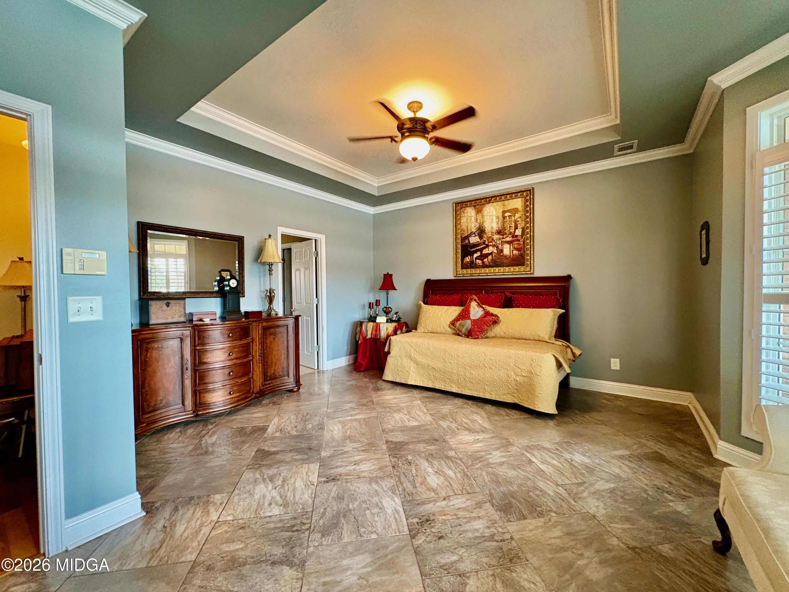 119 Bartlett Way Centerville, GA 31028 - Photo 16 of 48 a bedroom with a large bed and a chandelier