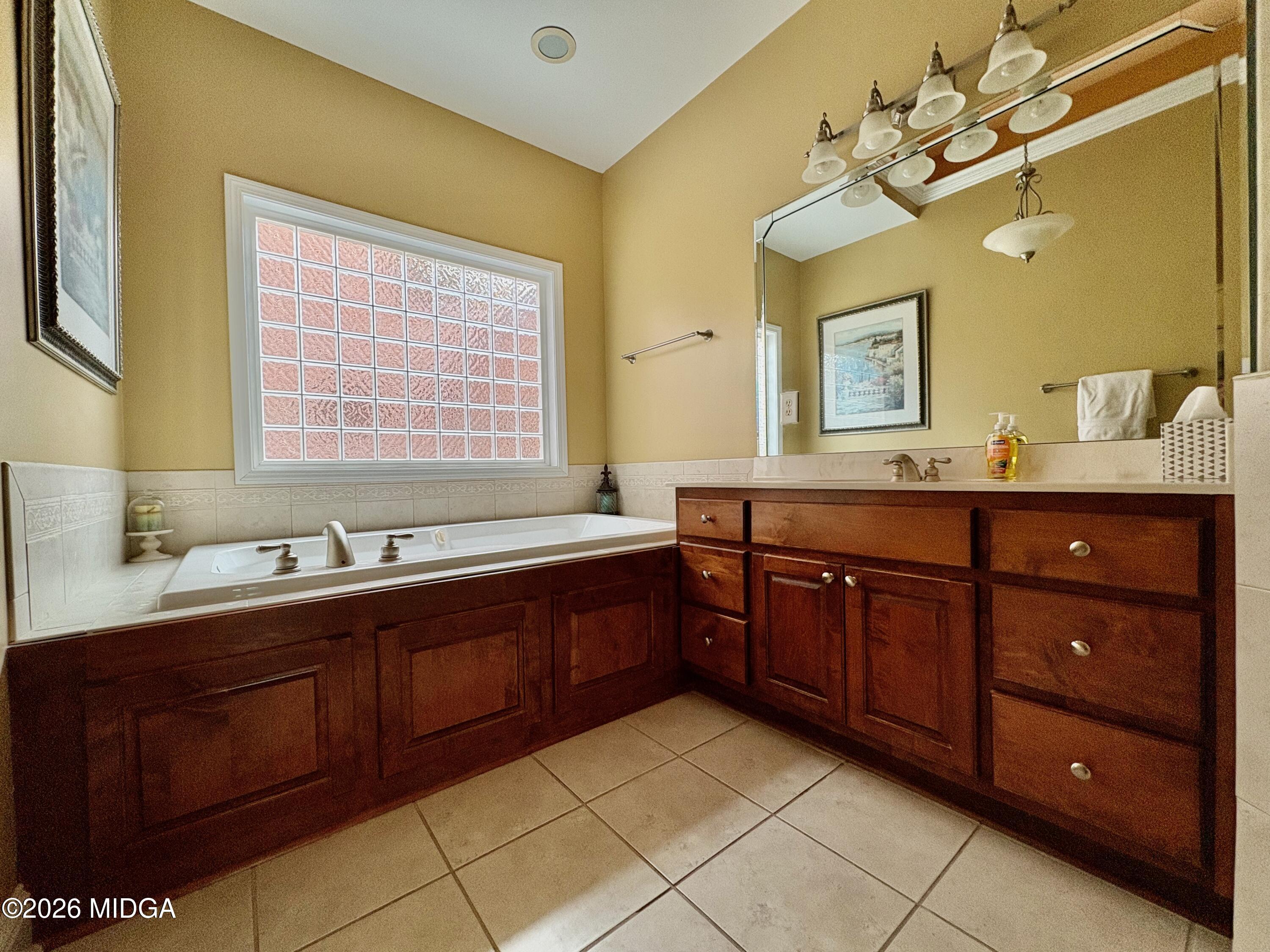 119 Bartlett Way Centerville, GA 31028 - Photo 18 of 48 a spacious bathroom with a granite countertop double vanity sink a mirror and a bathtub