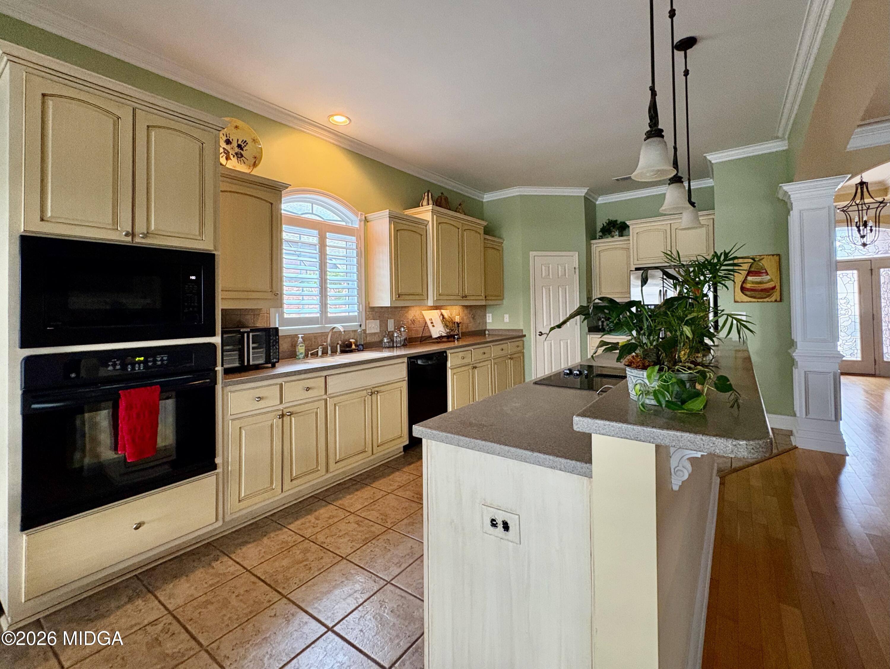 119 Bartlett Way Centerville, GA 31028 - Photo 10 of 48 a kitchen with stainless steel appliances kitchen island granite countertop a stove a sink and a microwave