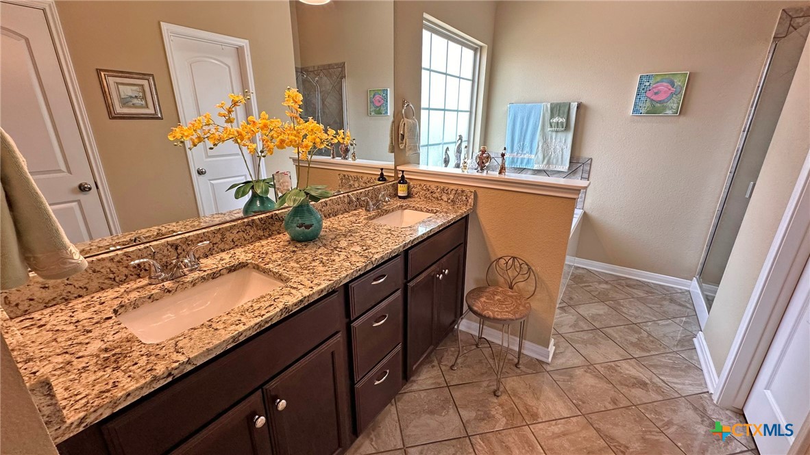 4709 Farrell Lane Killeen, TX 76549 - Photo 17 of 30 a bathroom with granite countertop a sink and a mirror