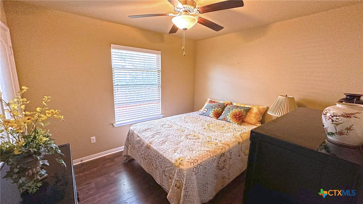 4709 Farrell Lane Killeen, TX 76549 - Photo 25 of 30 a bed sitting in a bedroom next to a window and a chandelier