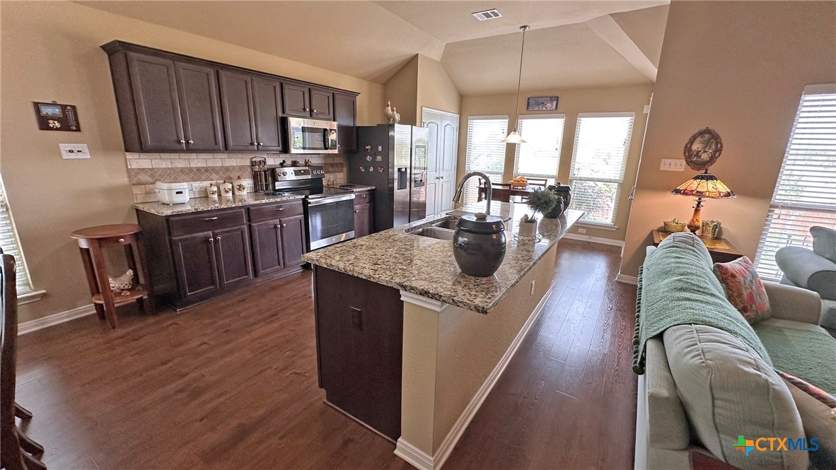 4709 Farrell Lane Killeen, TX 76549 - Photo 6 of 30 a living room with stainless steel appliances granite countertop furniture wooden floor and a view of kitchen