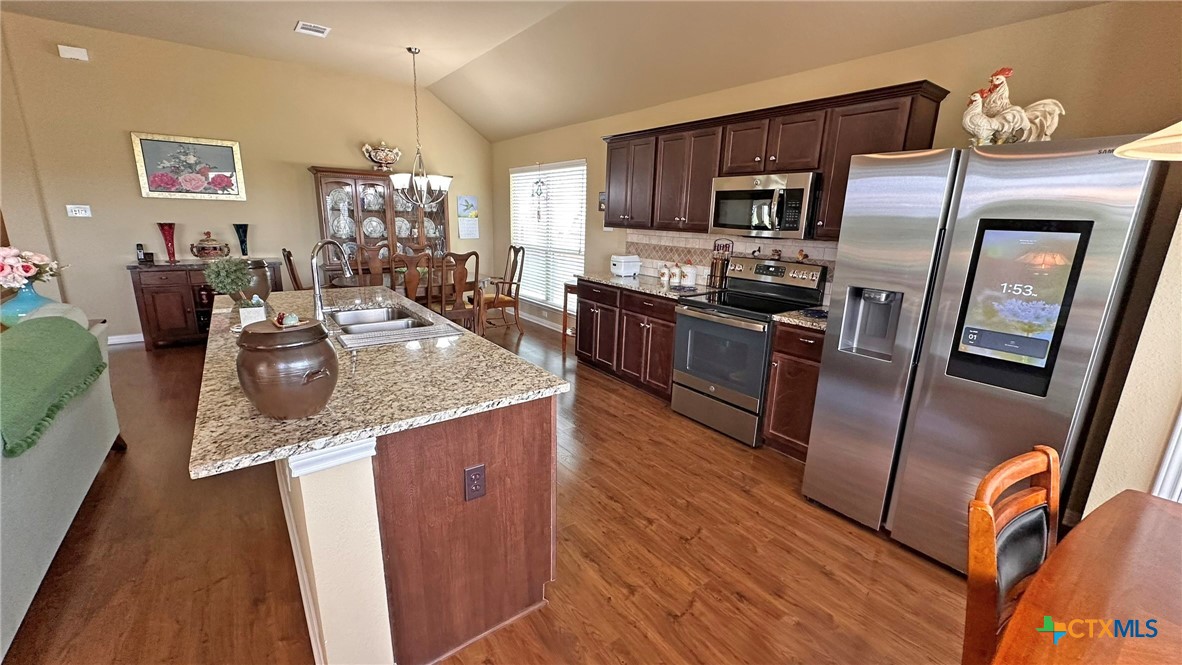 4709 Farrell Lane Killeen, TX 76549 - Photo 8 of 30 a kitchen with stainless steel appliances granite countertop a refrigerator a stove top oven a sink and dishwasher