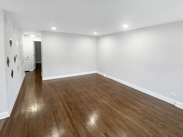 a view of a room with wooden floor and staircase