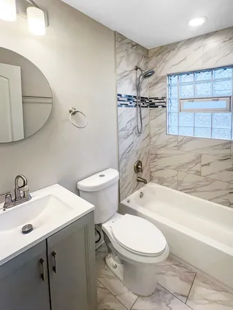 a bathroom with a toilet a sink and bathtub